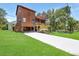 Exterior view of a two-story home with a lush green lawn and long driveway at 9501 Alice Ln, Riverview, FL 33578