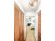 Hallway looking into bedroom with pale blue walls and neutral carpeting at 9501 Alice Ln, Riverview, FL 33578