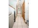 Hallway with tile flooring, closet space, and staircase access leading to additional living areas at 9501 Alice Ln, Riverview, FL 33578