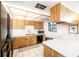 Functional kitchen features classic cabinetry, sleek countertops, and modern appliances, with views of the outdoors at 9501 Alice Ln, Riverview, FL 33578