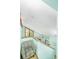 Bright stairway landing area with a cozy armchair, natural light, and tranquil views at 9501 Alice Ln, Riverview, FL 33578