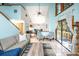 Bright living room featuring vaulted ceilings, a fireplace, and access to the outdoor deck at 9501 Alice Ln, Riverview, FL 33578