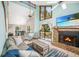 Bright living room features a stone fireplace, high ceilings, and sliding doors to a deck overlooking a lake at 9501 Alice Ln, Riverview, FL 33578
