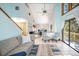 Inviting living room features soaring ceilings, neutral tones, comfortable seating, and access to outdoor deck at 9501 Alice Ln, Riverview, FL 33578