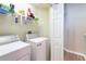 Bright laundry room features a washer, dryer, and storage shelving for convenience at 10214 Post Harvest Dr, Riverview, FL 33578