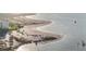Stunning aerial view of the sandy beach, clear water, and beachfront condos at 1100 Pinellas Bayway S # H2, Tierra Verde, FL 33715