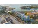 Overhead shot of condos with a pool, lush green landscaping, waterfront, and beautiful city views in the distance at 1100 Pinellas Bayway S # H2, Tierra Verde, FL 33715