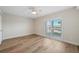 Light and airy bedroom featuring hardwood floors, ceiling fan, and bright window at 1100 Pinellas Bayway S # H2, Tierra Verde, FL 33715