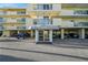 Exterior front entrance to building featuring covered parking and awning at 1100 Pinellas Bayway S # H2, Tierra Verde, FL 33715