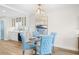 Dining area featuring a chandelier, modern art, and upholstered chairs at 1100 Pinellas Bayway S # H2, Tierra Verde, FL 33715