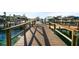 The wooden dock extends into the water with multiple boats docked nearby at 1100 Pinellas Bayway S # H2, Tierra Verde, FL 33715