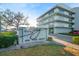 Exterior shot of the community sign, landscaped entrance, and condo building at 1100 Pinellas Bayway S # H2, Tierra Verde, FL 33715
