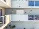 A close exterior view of the condo with multiple windows and balcony at 1100 Pinellas Bayway S # H2, Tierra Verde, FL 33715