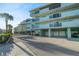 Exterior of the building showing balconies with garage parking underneath at 1100 Pinellas Bayway S # H2, Tierra Verde, FL 33715