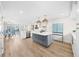 Bright, open kitchen featuring a large island, modern appliances, and hardwood floors at 1100 Pinellas Bayway S # H2, Tierra Verde, FL 33715