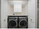 Bright laundry room features modern washer and dryer, plus built-in storage at 1100 Pinellas Bayway S # H2, Tierra Verde, FL 33715