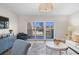 Cozy living room with sliding glass doors and serene outdoor views at 1100 Pinellas Bayway S # H2, Tierra Verde, FL 33715