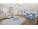 Open-concept living area featuring modern decor, kitchen access, and hardwood flooring at 1100 Pinellas Bayway S # H2, Tierra Verde, FL 33715