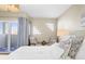 Bright main bedroom with comfortable seating, exterior balcony, and bright natural light at 1100 Pinellas Bayway S # H2, Tierra Verde, FL 33715