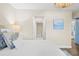 Bright main bedroom with a light color scheme, wood floors, and view of the en suite bathroom at 1100 Pinellas Bayway S # H2, Tierra Verde, FL 33715