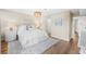 Spacious main bedroom with a light color scheme and decorative rug with a view of the hallway at 1100 Pinellas Bayway S # H2, Tierra Verde, FL 33715
