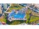Aerial view of luxurious pool area with lounge chairs, cabanas, and well-manicured landscaping in tropical setting at 1100 Pinellas Bayway S # H2, Tierra Verde, FL 33715