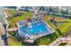 Aerial view of community pool and lounge area next to a boat dock at 1100 Pinellas Bayway S # H2, Tierra Verde, FL 33715