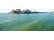 Picturesque waterfront view of island homes with boats docked along the coast at 1100 Pinellas Bayway S # H2, Tierra Verde, FL 33715