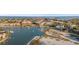 Scenic aerial shot showcasing waterfront homes, boat docks, a sandy beach, and tranquil bay waters at 1100 Pinellas Bayway S # H2, Tierra Verde, FL 33715