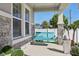 Close up of a cozy porch swing on a covered front porch with stone accents at 11006 Kidron Valley Ln, Tampa, FL 33625