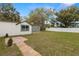 Backyard with a patio, grass, and white privacy fence at 1103 E Louisiana Ave, Tampa, FL 33603