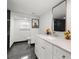 Renovated bathroom featuring a white vanity, marble floors, and modern fixtures at 1103 E Louisiana Ave, Tampa, FL 33603