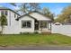 Charming home featuring a crisp black and white color scheme and a well-manicured front lawn at 1103 E Louisiana Ave, Tampa, FL 33603