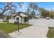 A charming two story home with white picket fence and a freshly graveled parking area at 1103 E Louisiana Ave, Tampa, FL 33603