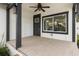 The spacious front porch features a ceiling fan and tile flooring, perfect for enjoying the outdoors at 1103 E Louisiana Ave, Tampa, FL 33603