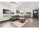 Bright living room featuring hardwood floors, neutral tones, and an elegant chandelier at 1103 E Louisiana Ave, Tampa, FL 33603