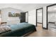 Bright main bedroom with wood floors, a large window, and access to closet and bathroom at 1103 E Louisiana Ave, Tampa, FL 33603