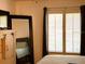 Bedroom featuring shuttered windows, TV, mirror, and comfortable bed at 1109 Pine Ridge W Cir # F1, Tarpon Springs, FL 34688