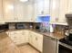 Kitchen featuring granite countertops, stainless steel appliances, and white cabinetry at 1109 Pine Ridge W Cir # F1, Tarpon Springs, FL 34688