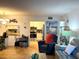 Comfortable living room view into kitchen featuring stainless steel appliances and white cabinetry at 1109 Pine Ridge W Cir # F1, Tarpon Springs, FL 34688