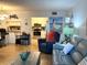 Comfortable living room view into kitchen featuring stainless steel appliances and white cabinetry at 1109 Pine Ridge W Cir # F1, Tarpon Springs, FL 34688