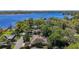 Aerial shot of a brown roof home with a screened pool close to a large lake in a lush area at 12010 Hardaman Pl, Tampa, FL 33618