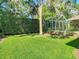 Lush backyard featuring a well-manicured lawn, privacy hedge, and mature trees for a serene outdoor space at 12010 Hardaman Pl, Tampa, FL 33618