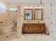 Elegant bathroom with a walk-in shower, a double vanity, and decorative mirrors at 12010 Hardaman Pl, Tampa, FL 33618