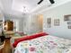 Bright bedroom featuring hardwood floors, chandelier, seating area, and large windows at 12010 Hardaman Pl, Tampa, FL 33618