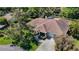 Expansive single-story home showcases a brick driveway, lush landscaping, and a charming front porch at 12010 Hardaman Pl, Tampa, FL 33618