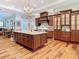 Stunning kitchen features a large island, custom cabinetry, and seamless flow to dining area at 12010 Hardaman Pl, Tampa, FL 33618