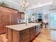 Open kitchen layout with a large island, custom cabinetry, and seamless flow to living areas at 12010 Hardaman Pl, Tampa, FL 33618