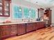 Bright kitchen with large windows, custom cabinets, granite countertops, and stainless steel appliances at 12010 Hardaman Pl, Tampa, FL 33618