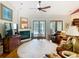 Comfortable living room features a cozy fireplace and lots of natural light to relax in at 12010 Hardaman Pl, Tampa, FL 33618